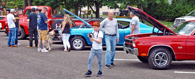 Happy people at North Jersey Auto Show looking at classic cars